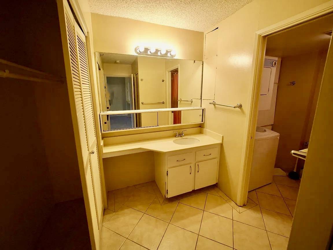 A bathroom with a sink, mirror, and toilet.,A bathroom with a sink, mirror, and toilet.